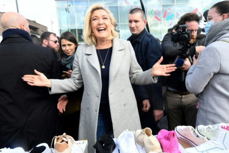France's far-right party Rassemblement National (RN) candidate for the 2022 French presidential election Marine Le Pen (C, pictured March 12, 2022) said she's 'never been so close to victory'