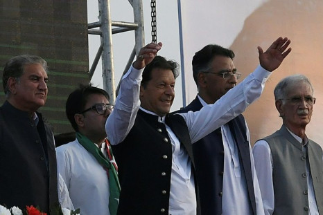 Pakistan Prime Minister Imran Khan raises his arms at a rally in the capital on March 27. Khan is fighting for his political life after the opposition raised a no-confidence vote against him in the National Assembly
