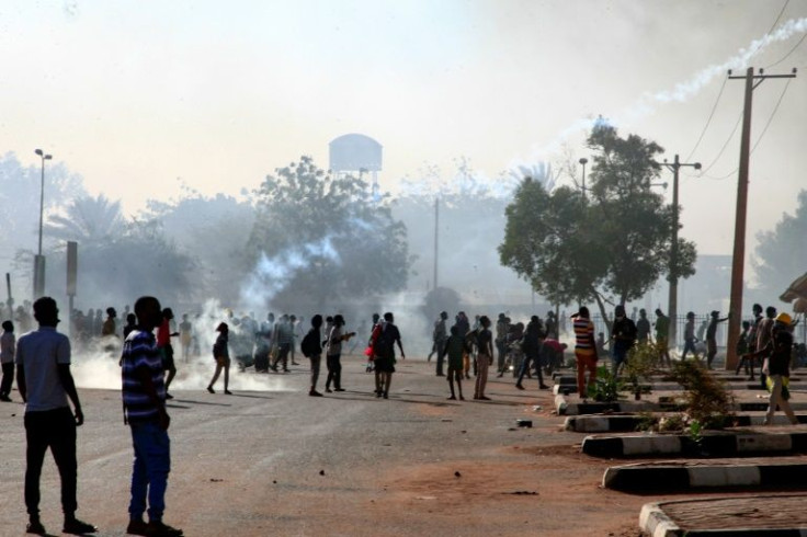 Sudanese protesters gather as security forces fire tear gas during a demonstration against the October 25 coup, in the capital Khartoum
